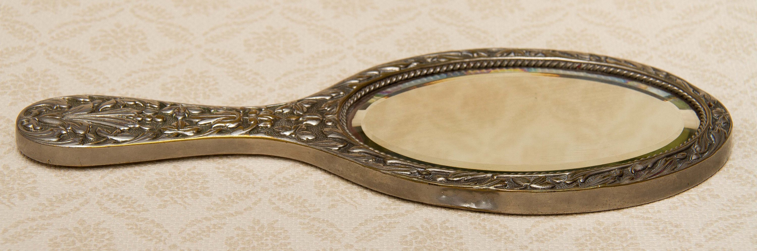 A quality vintage silver plated ornate hand vanity mirror. The mirror is a good weight and has a bevel edge mirror., Vintage Ornate Silver Plated Hand Mirror Vanity beveled edge oval mirror with handle dressing table mirror