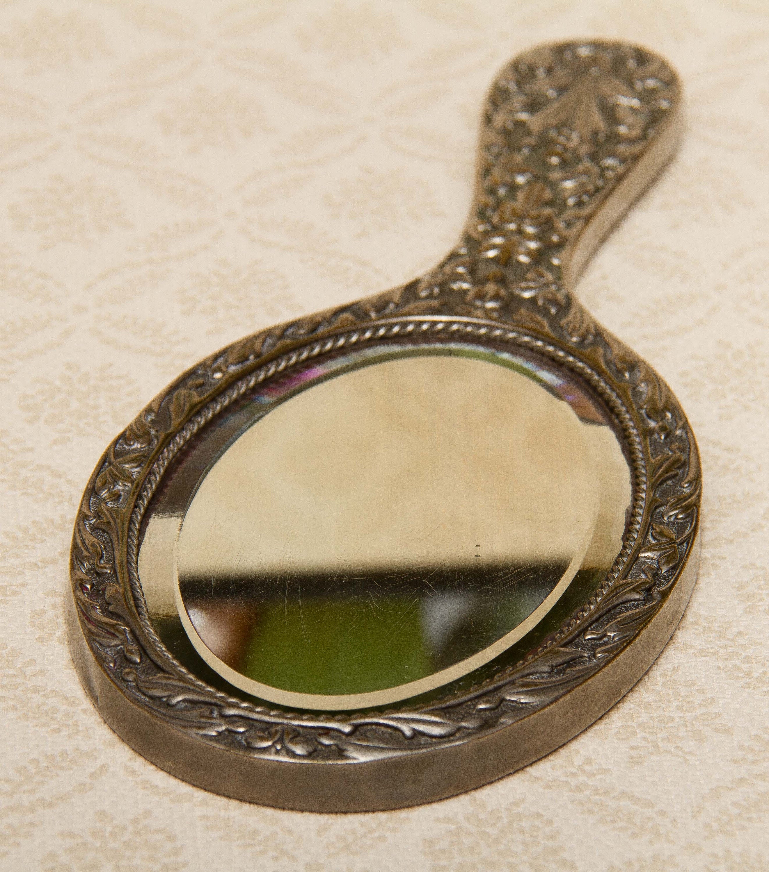 A quality vintage silver plated ornate hand vanity mirror. The mirror is a good weight and has a bevel edge mirror., Vintage Ornate Silver Plated Hand Mirror Vanity beveled edge oval mirror with handle dressing table mirror