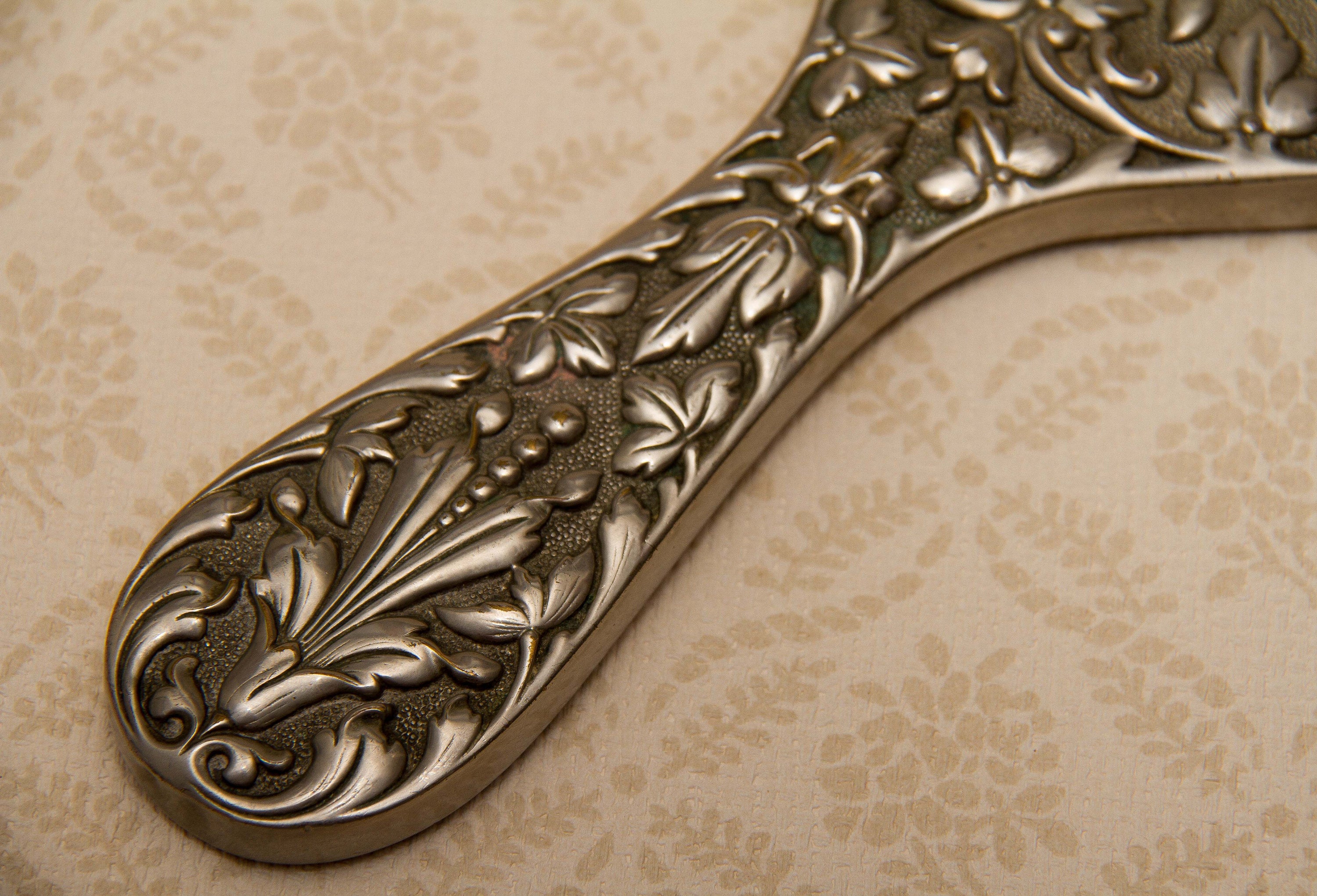 A quality vintage silver plated ornate hand vanity mirror. The mirror is a good weight and has a bevel edge mirror., Vintage Ornate Silver Plated Hand Mirror Vanity beveled edge oval mirror with handle dressing table mirror